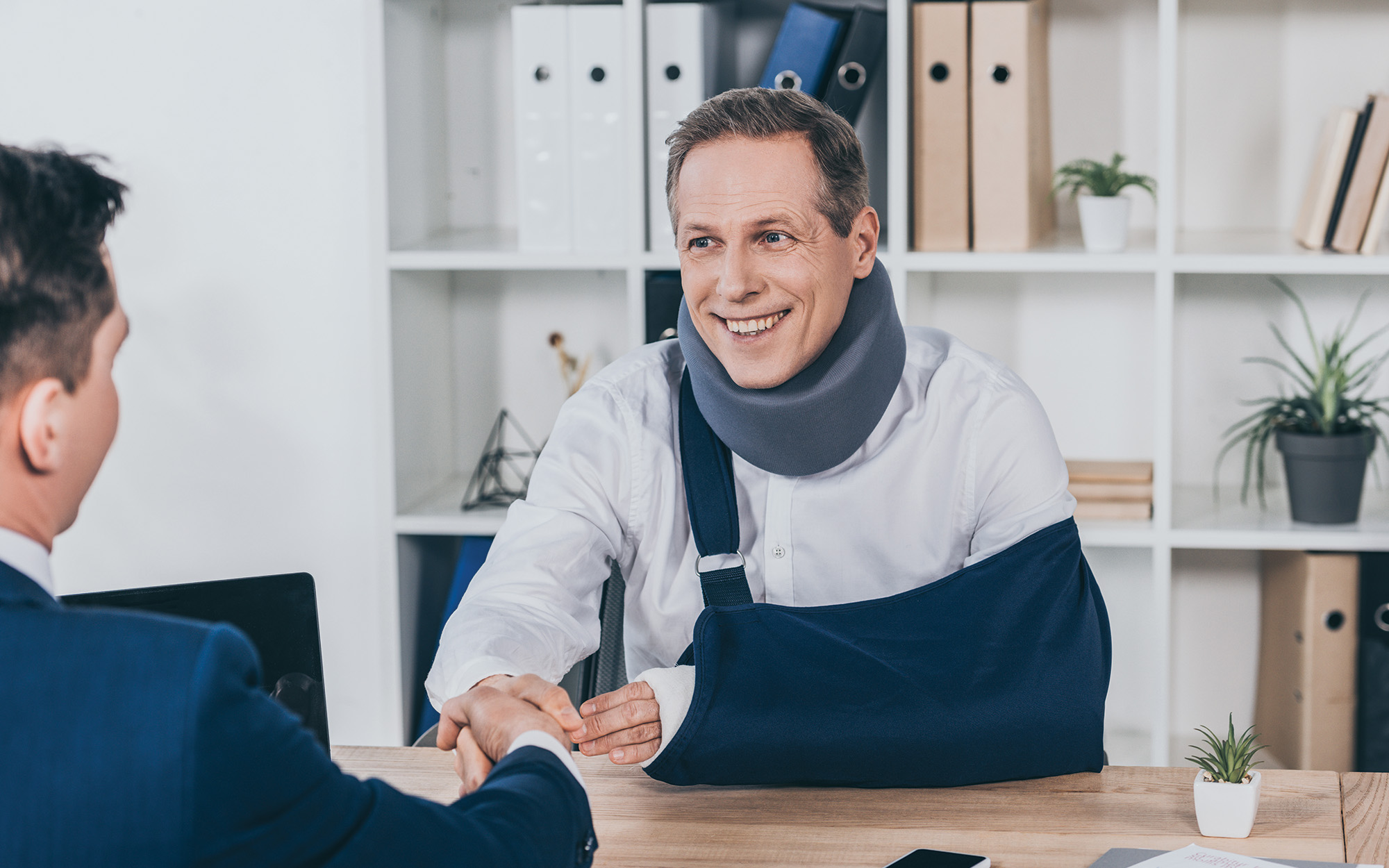 Men shaking hands with brace