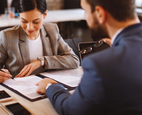 Young woman signs an employment contract