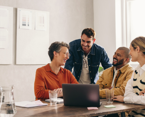 Coworkers Smiling Sitting at Office Table