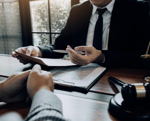 Image of two business people discussing legal paperwork.